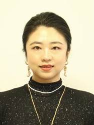 A person wearing a black shirt and gold necklace Description automatically generated